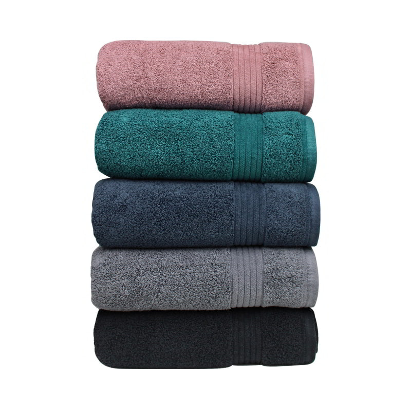 alt="A pile of folded various colour of Bath towel featuring its premium-quality  cotton and high level of softness."