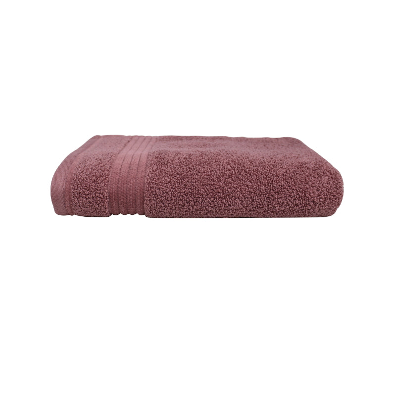 alt="Close-up image of a premium pink hand towel, showcasing details and high-quality craftsmanship in the side view."