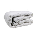 alt="Side angle view of the folded quilt crafted washable wool for decadently cosy warmth"