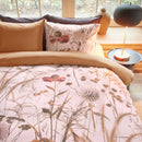 Bedding House Cely Multi Quilt Cover styled in a warm timber bedroom with floral detailing