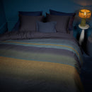 Full bed view of Lenny Blue quilt cover set with stylish stripe layout in a dark bedroom