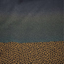 Detail shot of pillow and quilt corner with soft satin texture and printed dots