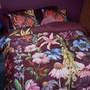 Full view of the quilt cover in a purple-toned bedroom with warm decorative accents