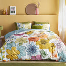 Reversible Bedding House Lotti Quilt Cover shown with tranquil blue-grey underside folded back