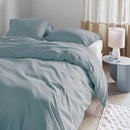 Wrinkle-textured blue grey quilt cover shown on bed with soft natural lighting and neutral curtains