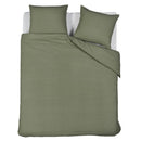 Full bed view of the Summer Seersucker Green set in a minimal natural-toned bedroom