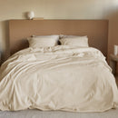 Sand-coloured seersucker quilt cover set styled in a warm-toned bedroom