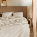 Side view of bed dressed in Summer Seersucker Sand quilt cover with matching pillows