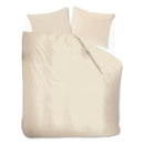 Top view of the soft, airy cotton quilt cover in sand with relaxed, casual drape over bed