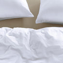 Soft white seersucker quilt draped casually over a bed for a relaxed look

