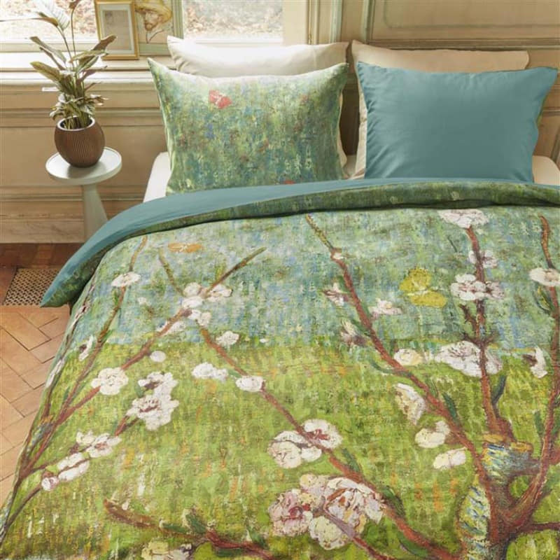 alt="Side view of a quilt cover inspired by Vincent van Gogh's 'Blossoming Peach Tree' painting in a cosy bedroom."