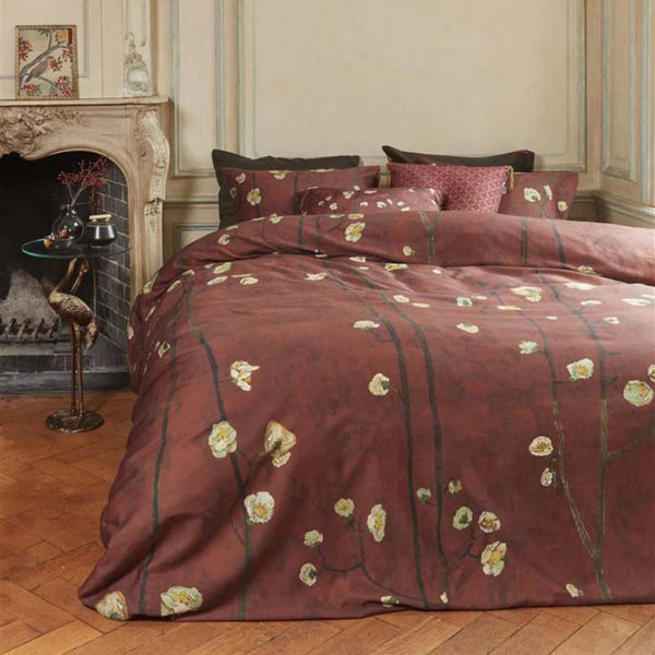 alt="Japanese-inspired quilt cover with a vibrant flowering plum orchard pattern on a deep red background."