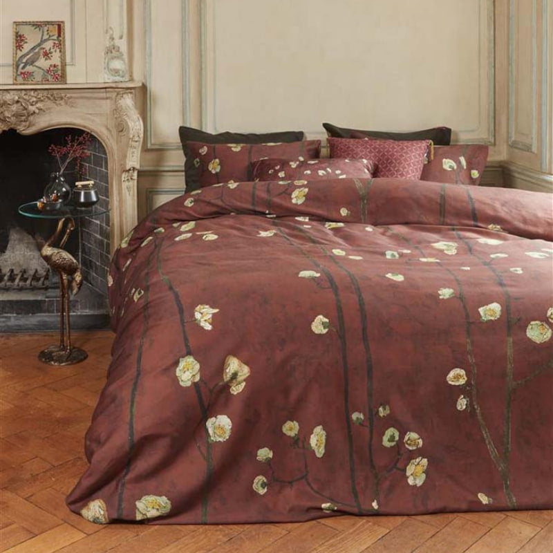 alt="Japanese-inspired quilt cover with a vibrant flowering plum orchard pattern on a deep red background."