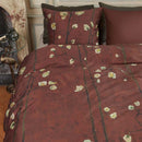 alt="Top view of a Japanese-inspired quilt cover with a vibrant flowering plum orchard pattern on a deep red background."