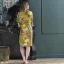 alt="A woman wearking Van Gogh-inspired Almond Blossoms kimono with gold background"