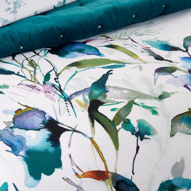 Close up detail of a gardenia prussian print quilt cover set, creating a tranquil and inviting atmosphere.