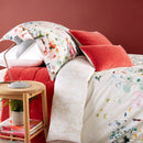 A cosy bedroom featuring iris garden quilt cover set, highlighting a tranquil atmosphere with elegant bedding.