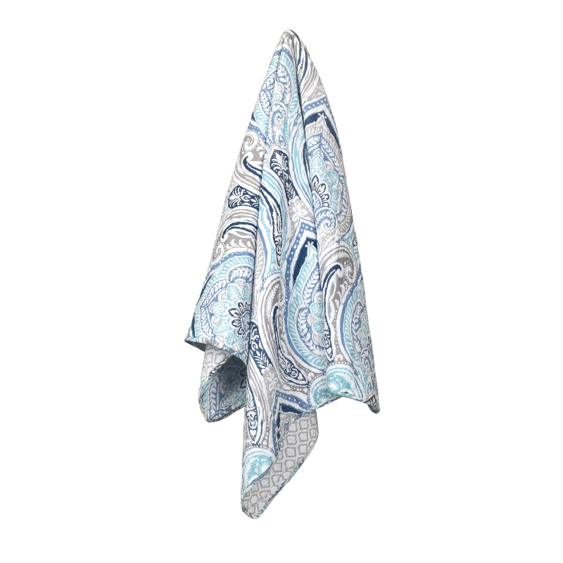 alt="A beautiful throw designed with heritage flower and foliage pattern in blues and greys in a luxurious bedroom"