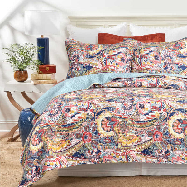 Diverse colour palette of coverlet set with rich tapestry-like pattern, vibrant mix of floral motifs, undulating shapes, and mythical creatures. 