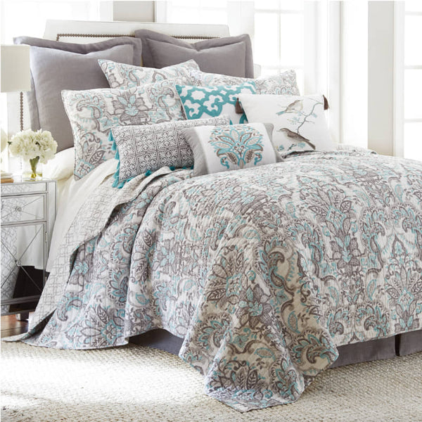 alt="A beautiful cotton coverlet set designed with a leaf pattern in a cosy bedroom"
