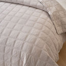 Classic Quilts Square Sand Coverlet styled neatly on a bed with matching pillowcases.