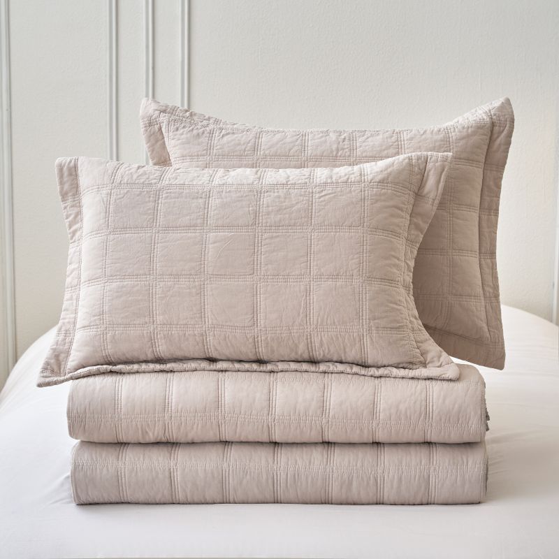 Classic Quilts Square Sand Coverlet styled neatly on a bed with matching pillowcases.