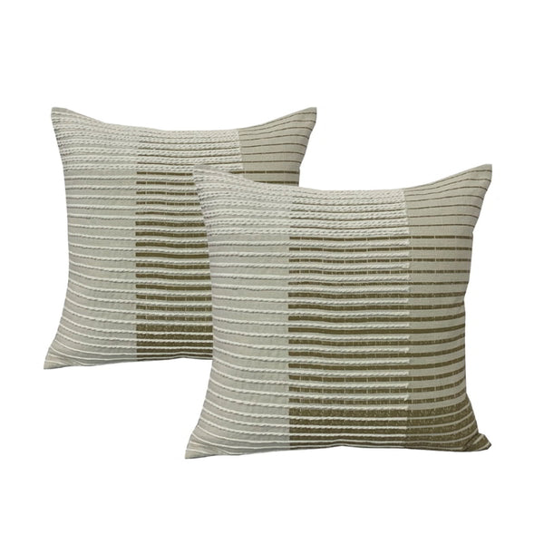 alt="Exquisite twin pack feather-filled cushions in olive showcase a mesmerising interwoven line pattern. Meticulously crafted from fine cotton tape, these cushions create a captivating optical illusion, breathing life into a graduating linear design."