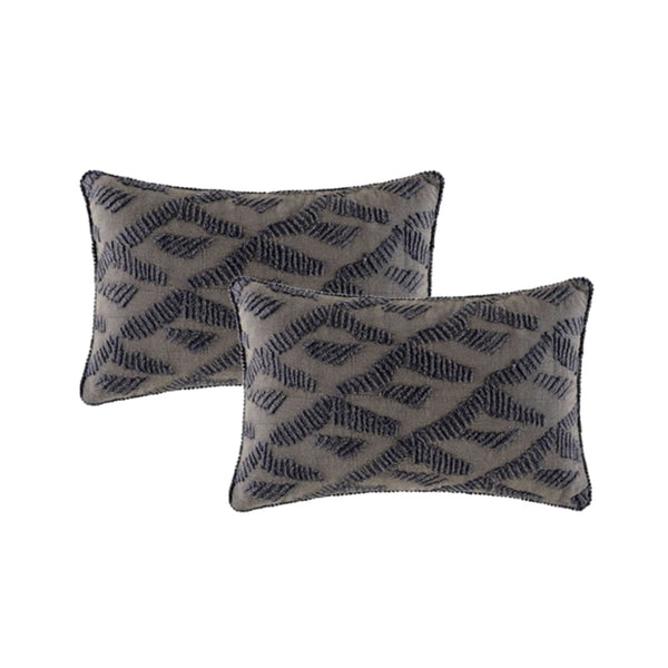 A pair of feather-filled cushions showcasing intricate geometric patterns, adding a touch of refinement to any luxurious setting.