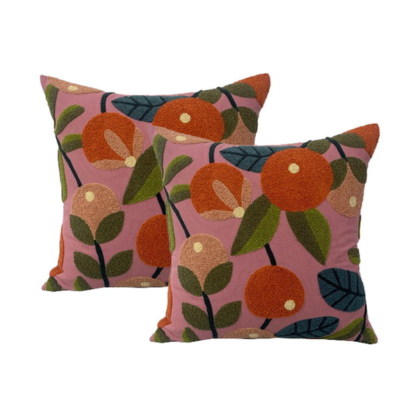 alt="Luxurious polyester-filled cushions adorned with vibrant orange and green leaf motifs, exuding elegance and nature's beauty."