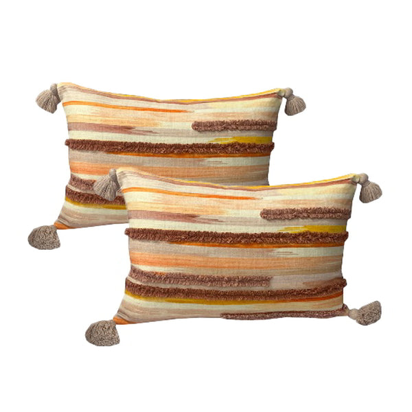 alt="Luxurious twin pack feather-filled cushions adorned with vibrant orange and brown stripes, enhanced by boucle-stitched detailing and charming tassels."