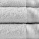 Detailed shot of a stack of luxurious grey towels made from eco-friendly Tencel and cotton, promoting sustainability and advanced hygiene.