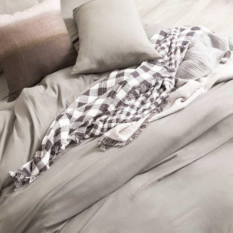 Luxurious bed with gray and white plaid blanket, adorned with granite microfibre quilt cover set.