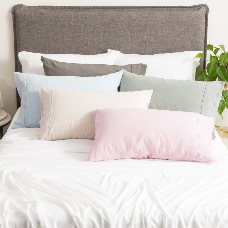 Sumptuous bed adorned with exquisite pillows, epitomising luxury and providing a seamless aesthetic for your bedding.