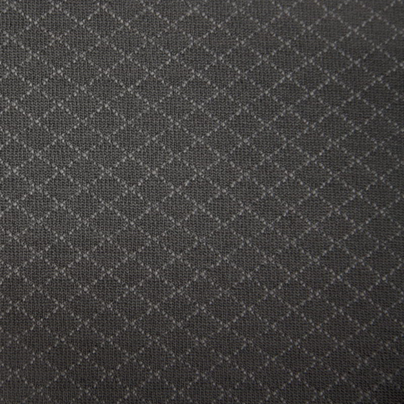 Close up look grey recliner chair covered with a textured slipcover, enhancing comfort and style.