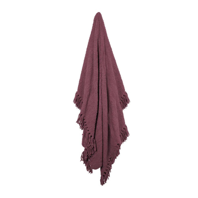 Hanging details of a throw with chevron weave, knotted fringe on each side, trendy winter colours for on-point styling.