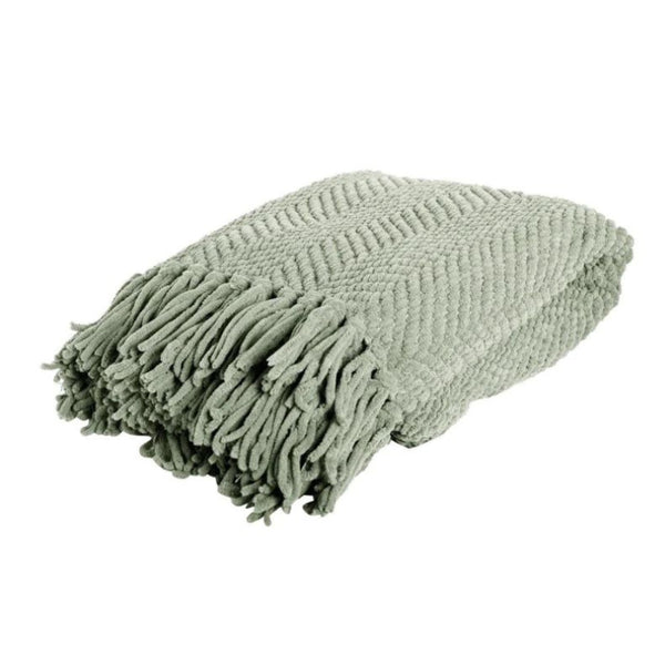 A green throw with fringes, part of the J.Elliot winter collection, featuring a chevron weave and trendy winter colours.