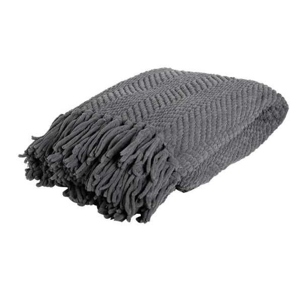 A grey blanket with fringes on each side featuring a chevron weave and trendy winter colours.