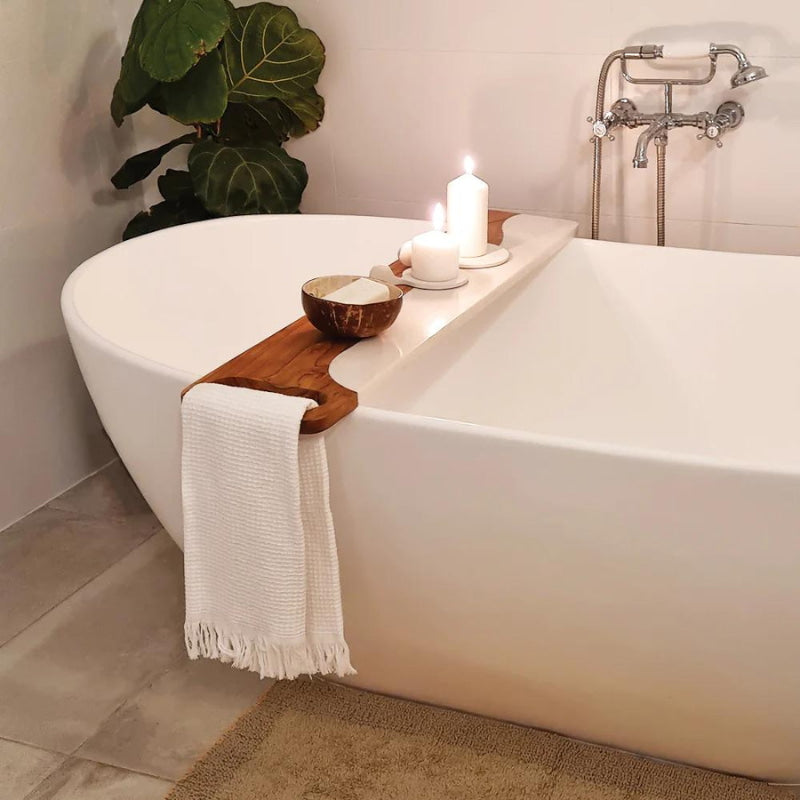 alt="A white multi purpose tray in an elegant bath tub"