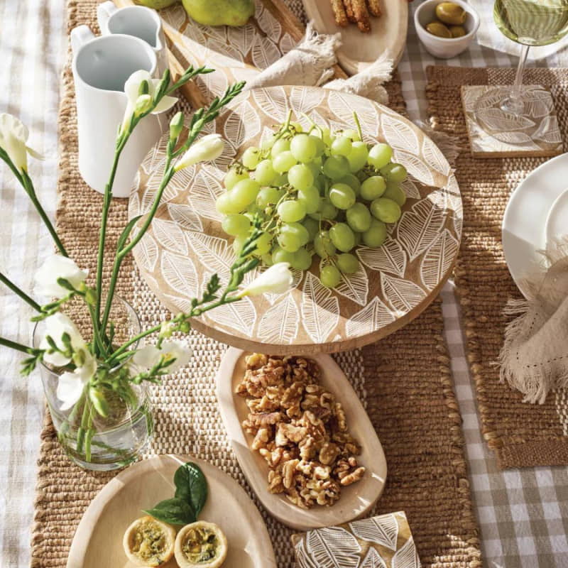 alt="A Taupe placemat with other collections featuring its beautiful waffle weave on the front."