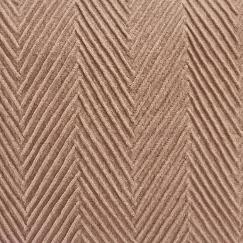 alt="Close up details of a stunning brown cushion with an embossed chevron design on high-quality cotton fabric"