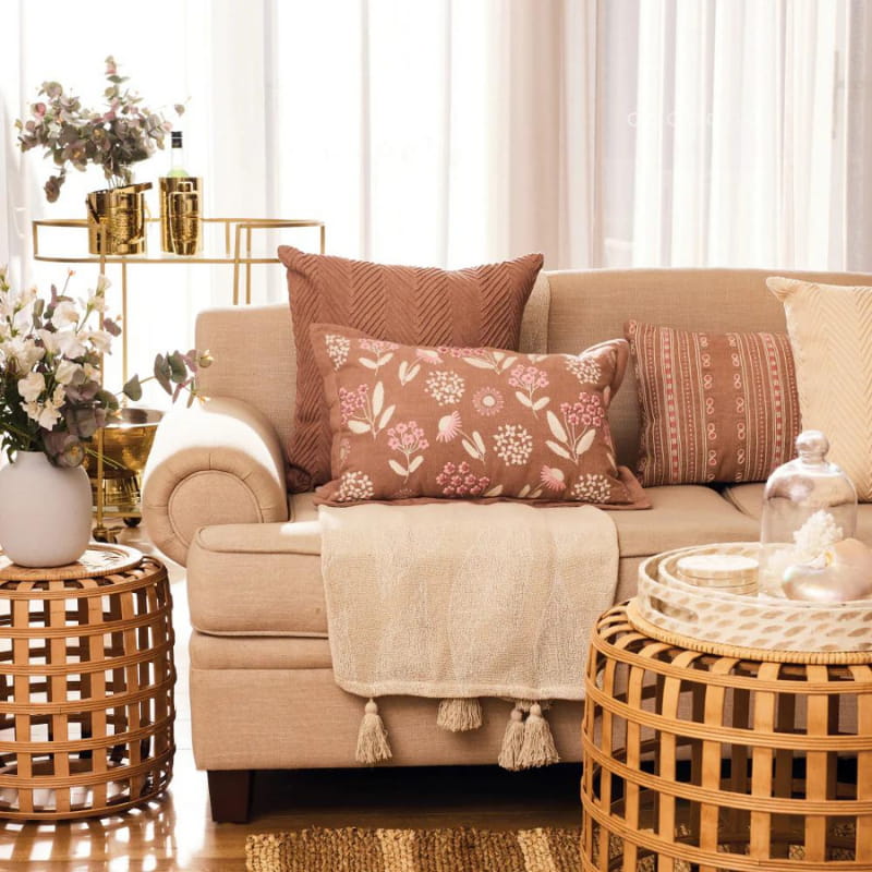 alt="Stunning cushions in natural hues in an aesthetic living space"