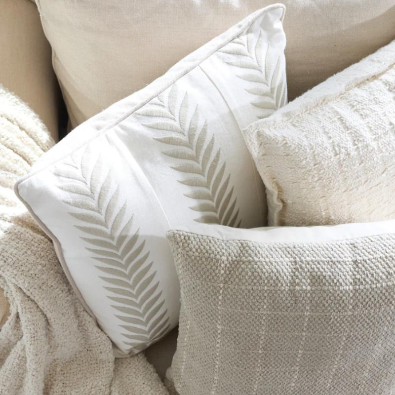 alt="A group of soft, durable cream square cushions"