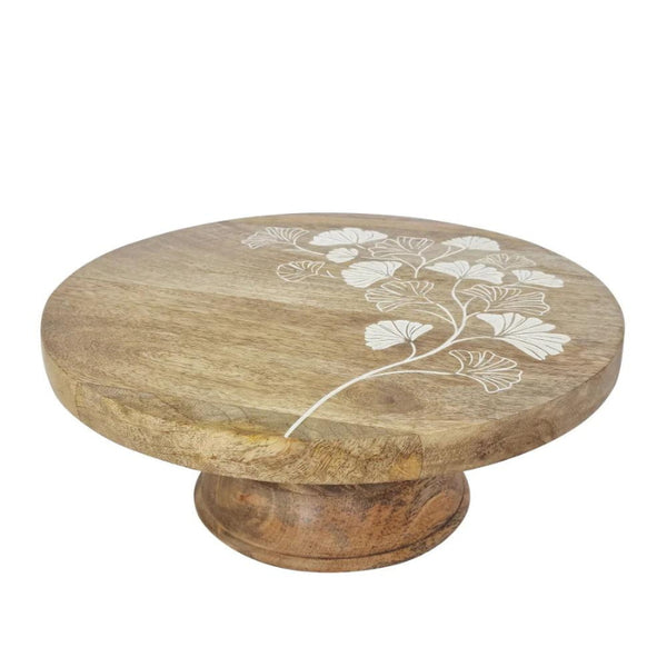 alt="Details of a natural cake stand featuring hand-carved with a delicate ginkgo leaf design"