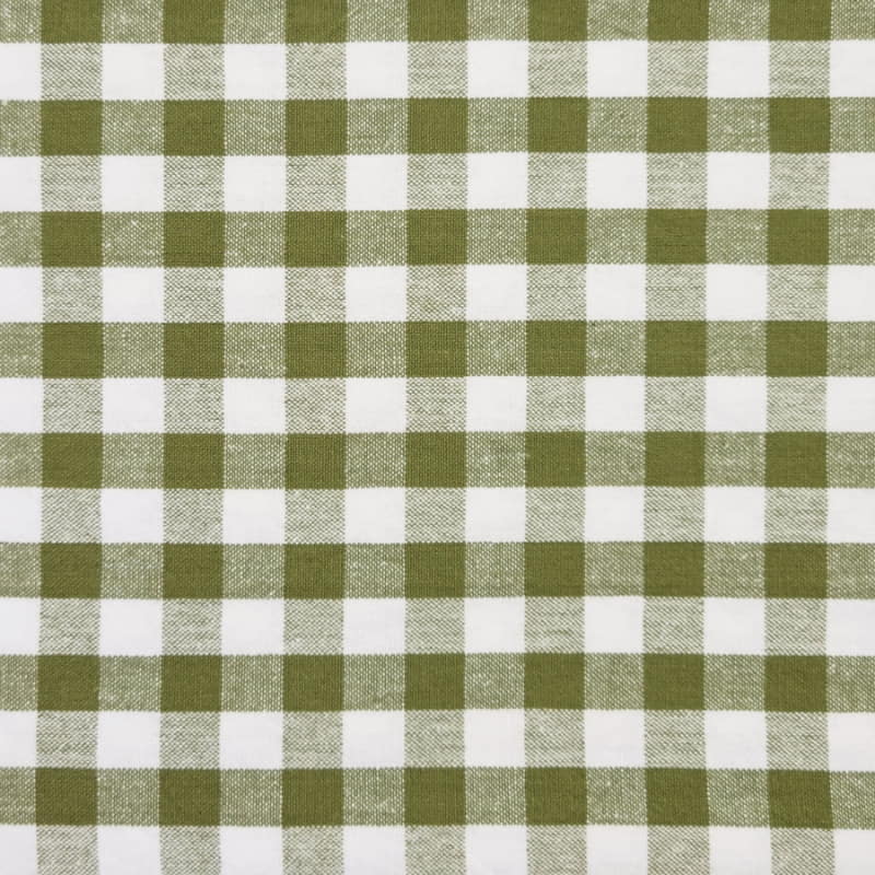 alt="a close-up of a green and white patterned fabric"