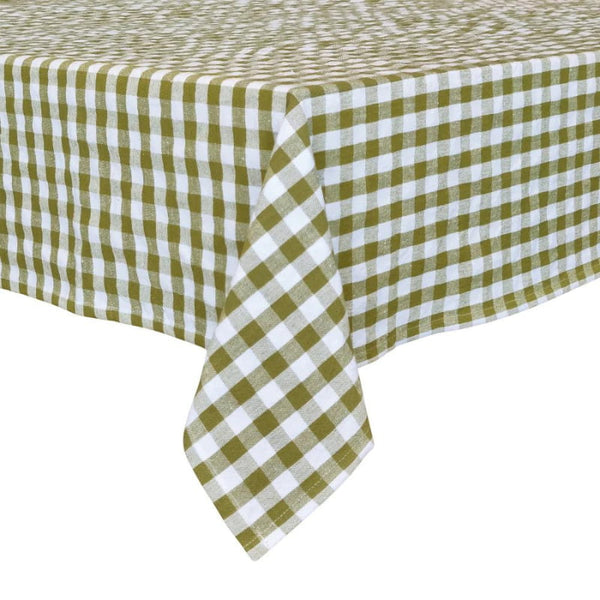 alt="an edge of a  patterned tablecloth in white and green colours" 