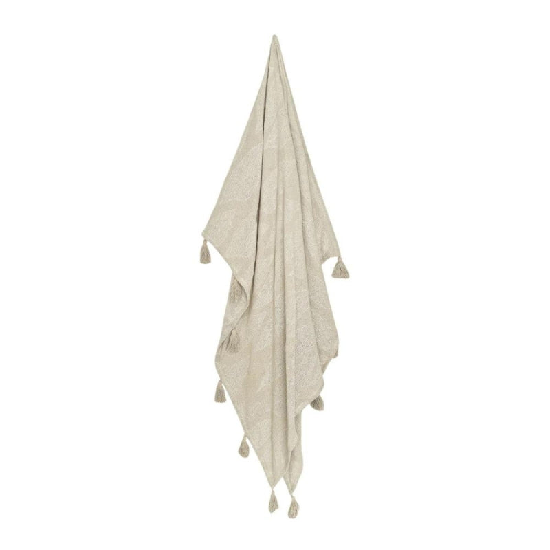 alt="A hanging cream and white throw featuring a leaf design pattern"