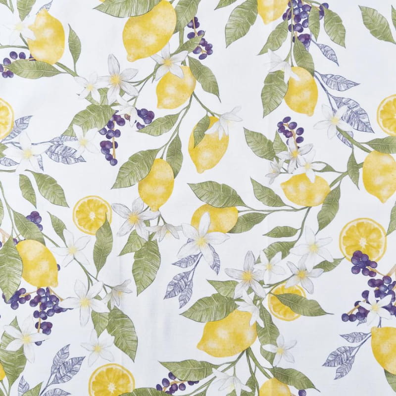 alt="a close up details of a white fabric showcasing a printed lemons and flowers"