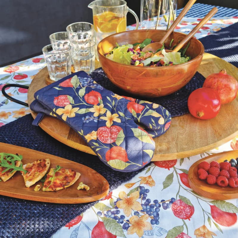 alt="2 pieces blue oven mitts featuring a pomegranate and floral design in a luxurious table setup"