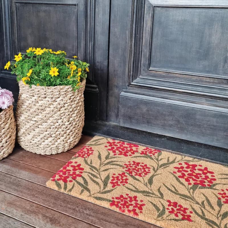 alt="A native flower mat in front of door featuring its high quality coir materials and unique designs."
