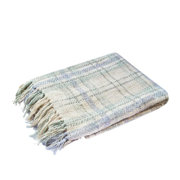 alt="A green multicoloured throw features a playful check pattern weaved from different coloured string, with tassels on each side"